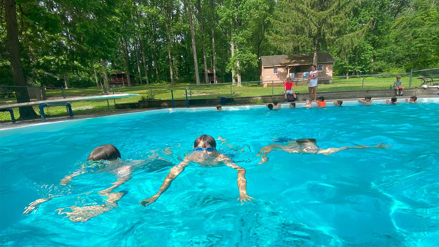 Campers getting instructional swim