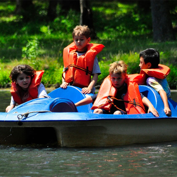 Campers on the lake in a paddle boat